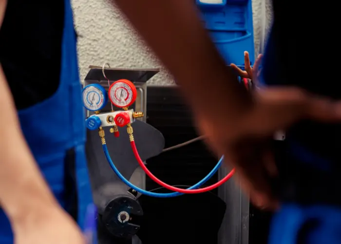 An AC technician preforming maintenance on an AC unit